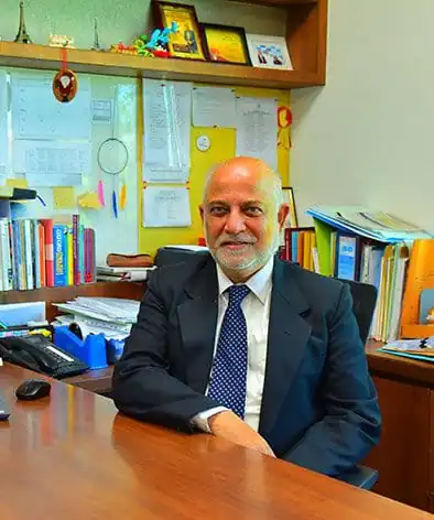 Mr. Louis Dias, Principal of Greenwood High Bannerghatta, sitting at his desk in his office